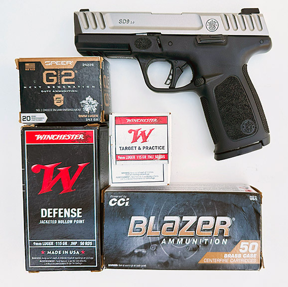 S&W SD9 2.0 9mm semi-auto handgun with boxes of Winchester, CCI, and Speer ammunition