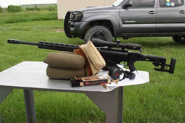 Ruger Precision Rifle in .300 PRC on a shooting bench with hearing protection, ammunition, and shooting bags