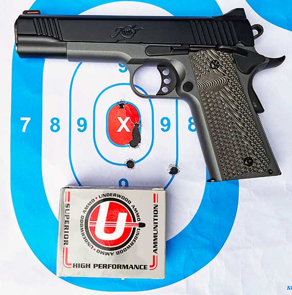 Kimber LW Shadow Ghost .45 ACP 1911 handgun on a paper target with a box of Underwood ammunition