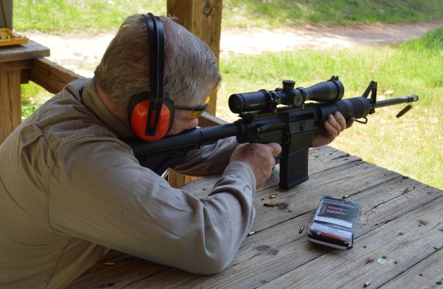 man sighting-in a rifle on range