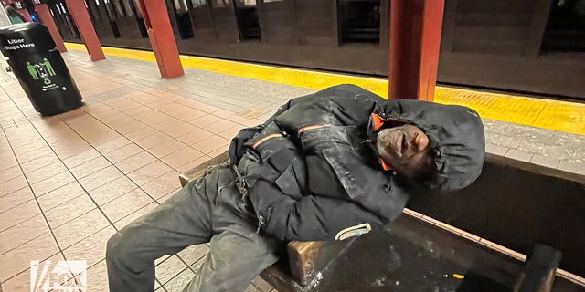 Man sleeping in subway station. 