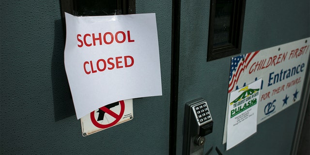 school closed sign taped on door