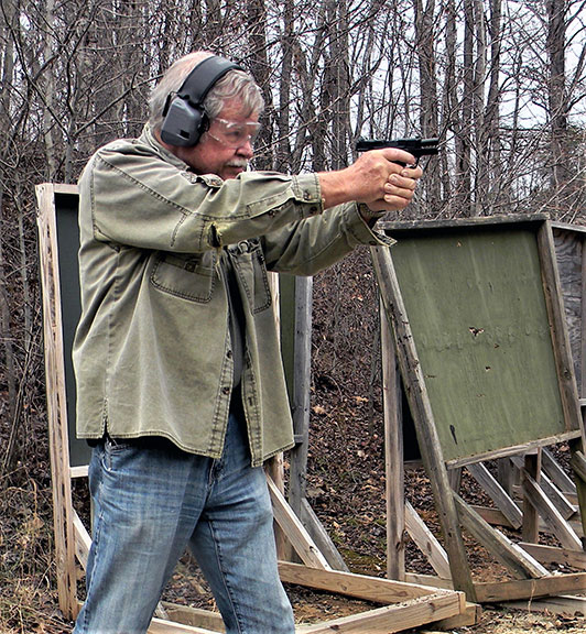 Bob Campbell Shppting the Smith and Wesson CSX with a two handed grip at an outdoor firing range