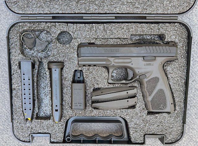 Taurus TS9 9mm semi-automatic handgun in a carrying case with two magazines, grips, and loading tool