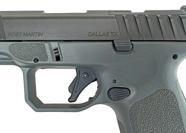 grip texture, straight flat-face trigger, slide lock, and familiar Glock-type breakdown tabs on the Rost Martin RM1C 9mm pistol