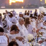 Dinner party has guests bringing tables, dressing in white and learning location last-minute