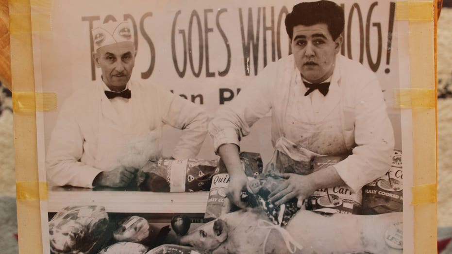 Meatcutter stands at Tops Market counter in 1963.