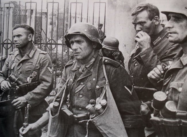 german soldier with two bags of stick grenades