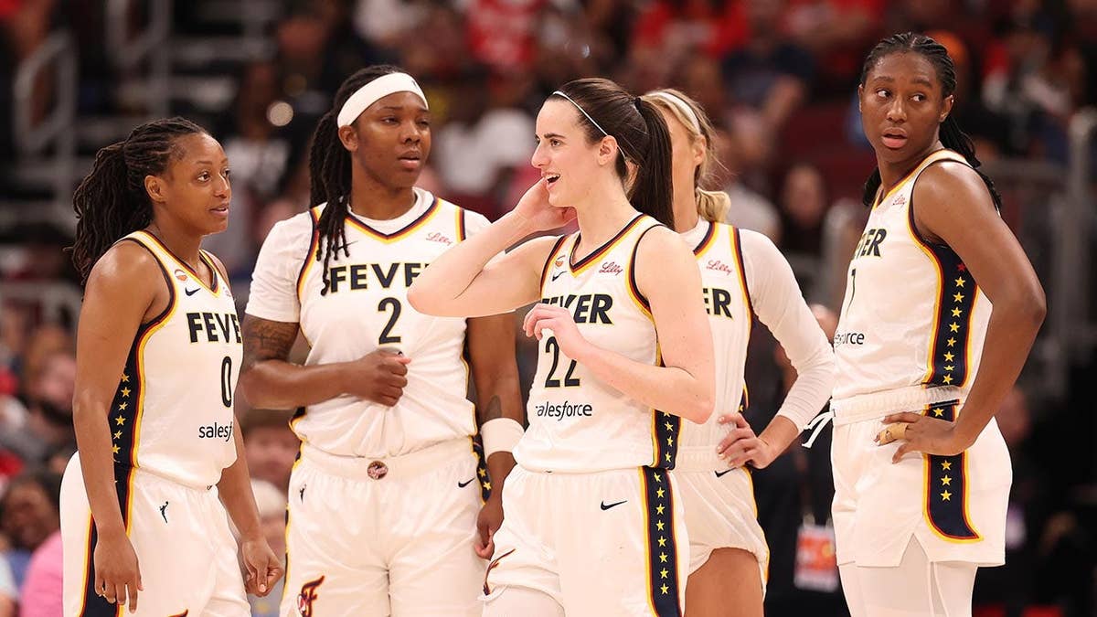 Indiana Fever players huddle during a game