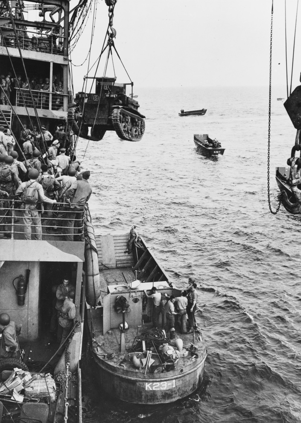 US Marine Corps M2A4 Stuart light tank hoisted from USS Alchiba AK-23 into a LCM landing craft off the Guadalcanal invasion beaches on the first day of landings