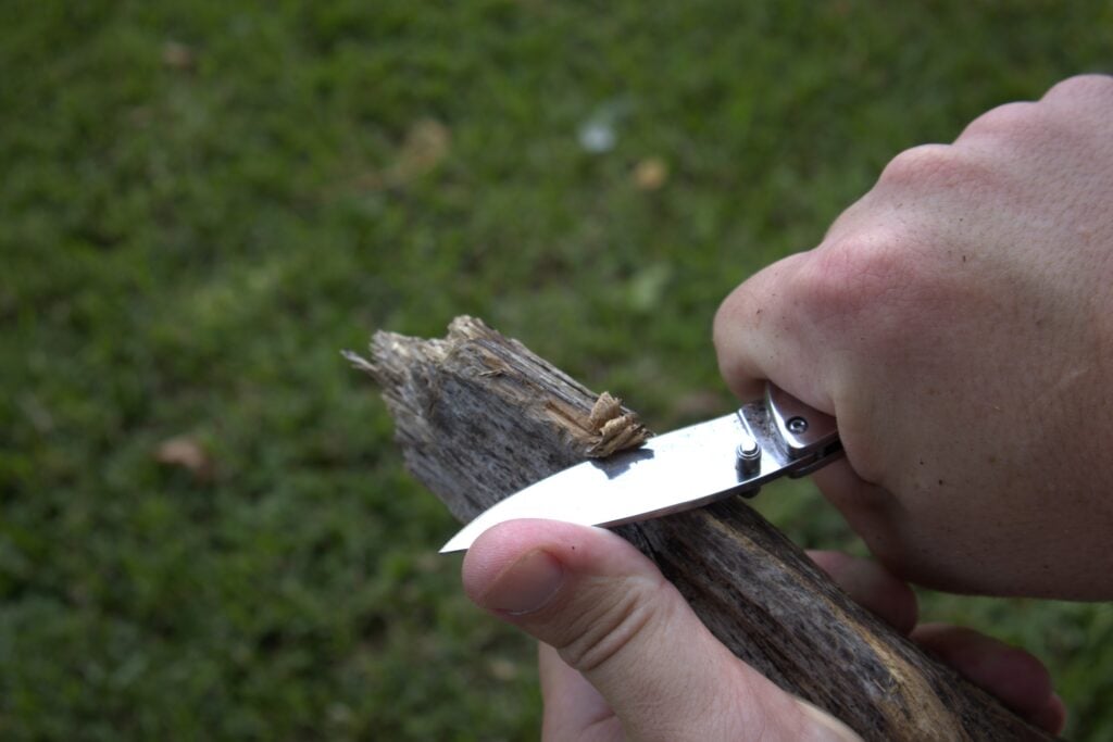 bear & son 3 3/4 inch slide lock folder knife cutting into wood