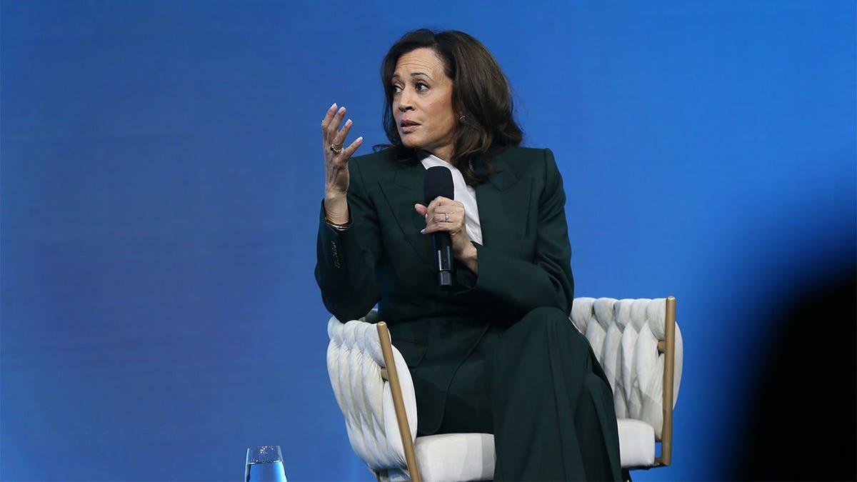 Kamala Harris speaks at a podium during the Austrian World Summit in Vienna.