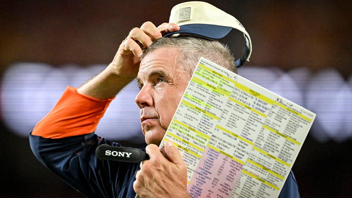 Sean Payton scratches his head on the sideline at Arrowhead Stadium.