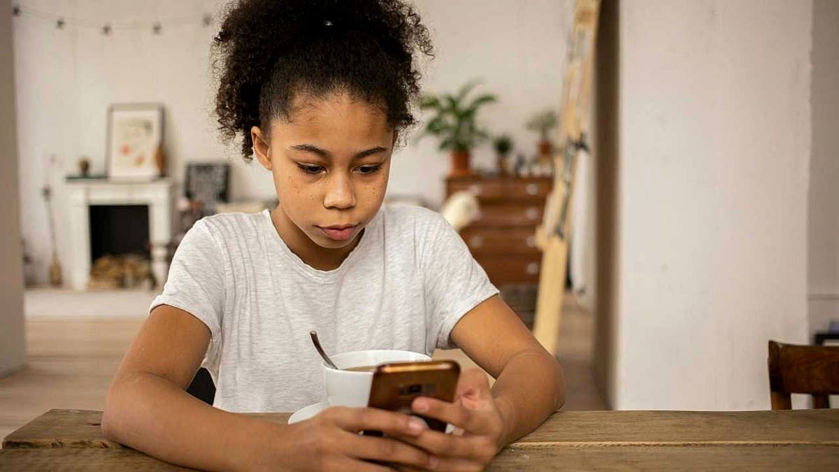 A girl uses a smartphone.