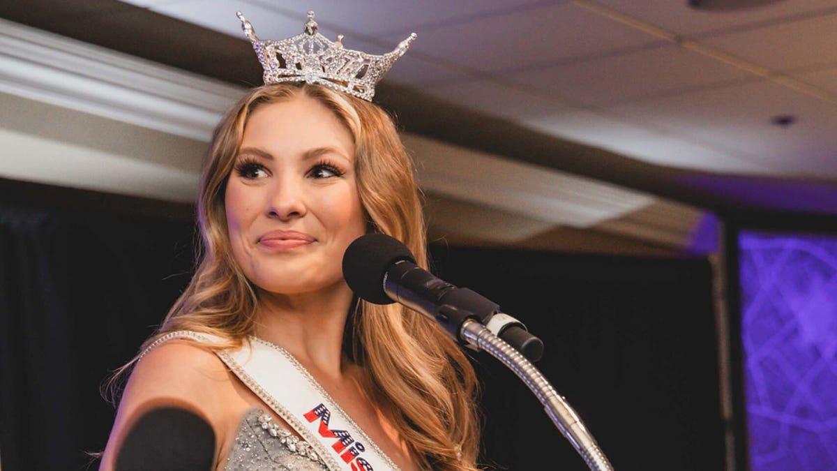 Ashlyn Mercier wearing a tiara and sash looking away.
