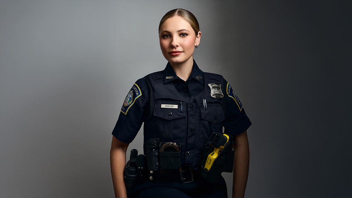 Ashlyn Mercier in police uniform looking serious.