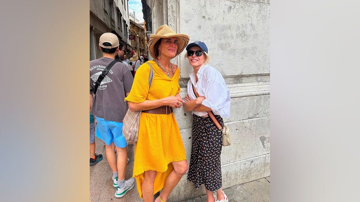 Brooke Shields poses with Chelsea Handler while wearing a bright yellow dress and straw hat during their trip to Croatia.