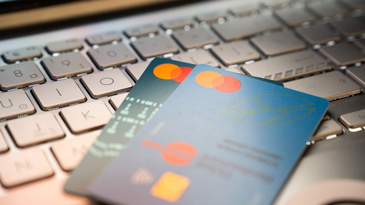 Credit cards laying on a computer keyboard.