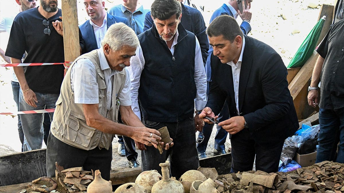Men assessing archaeological finds in Georgia
