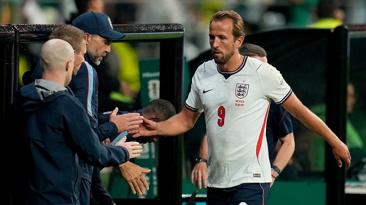 Harry Kane walks off the field during a soccer match in Mexico City.