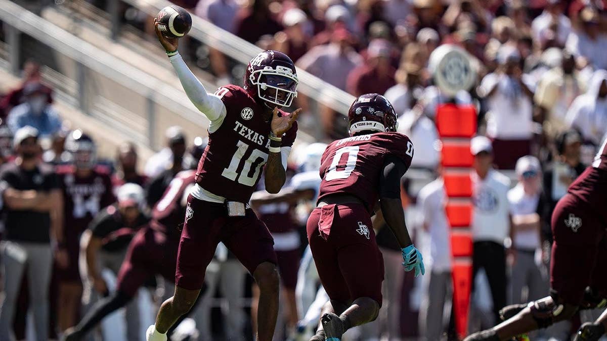 Marcel Reed throwing a pass during a college football game at Kyle Field