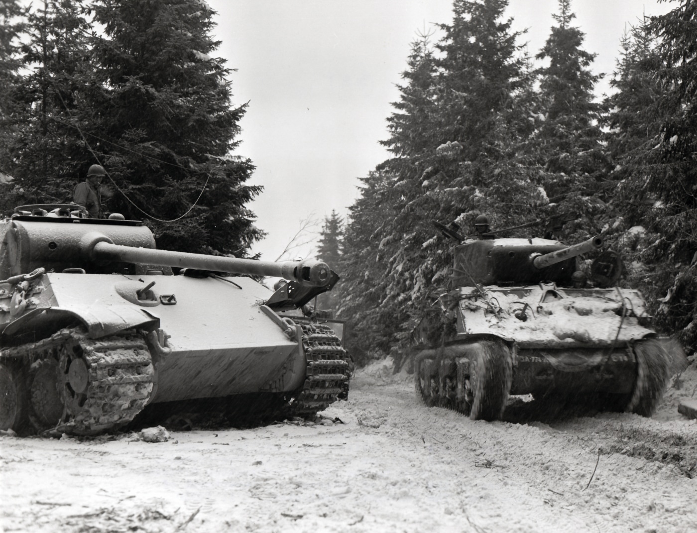 Sherman tank passes Panther tank in Belgium during January 1945