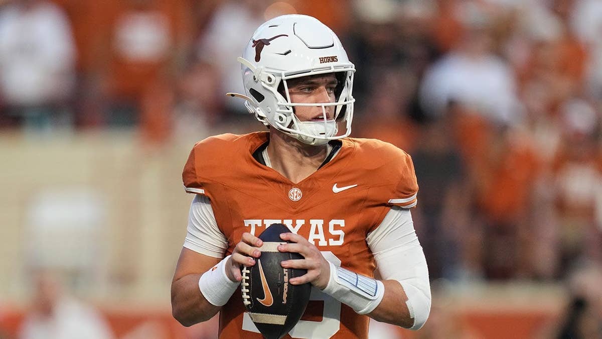 Arch Manning drops back to pass during a college football game