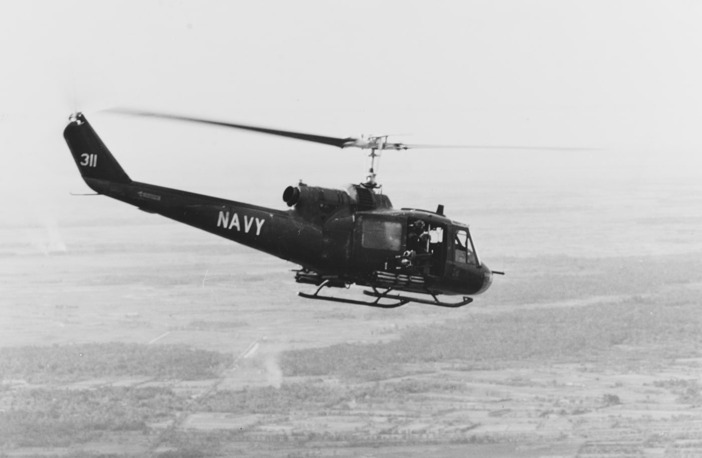 UH-1B Iroquois Helo from Helo Light Squadron Three flies over the Mekong Delta on a strike mission