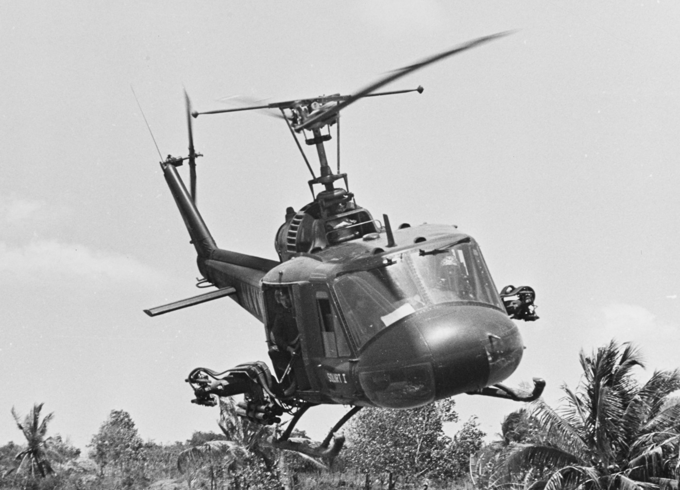UH-1B circles over canal in Mekong Delta while supporting a patrol boat