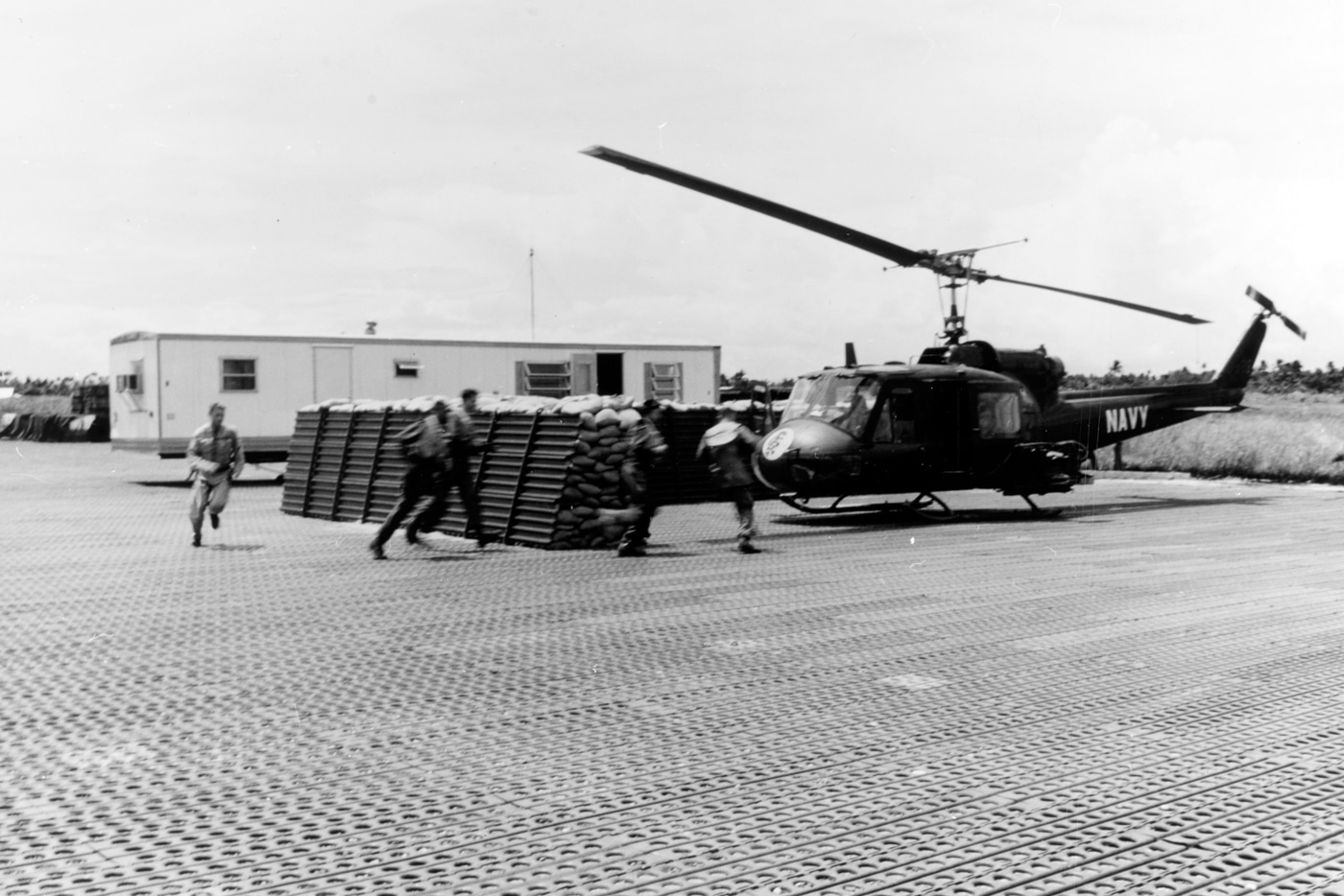 US Navy UH-1 attack helicopter crewmen respond to a call for combat air support over the Mekong Delta