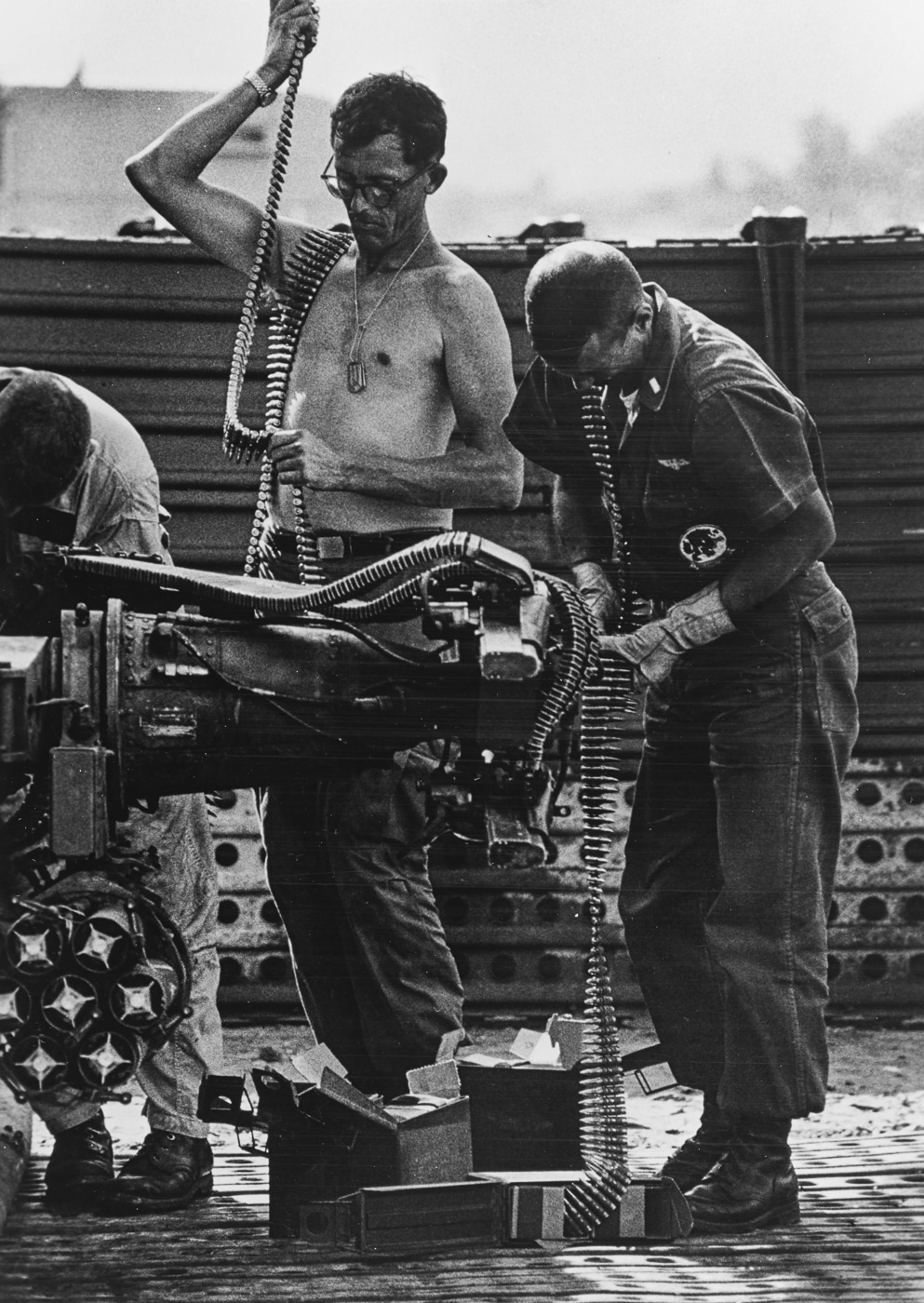 US Navy crewmen load the M60 machine gun on a UH-1B helicopter