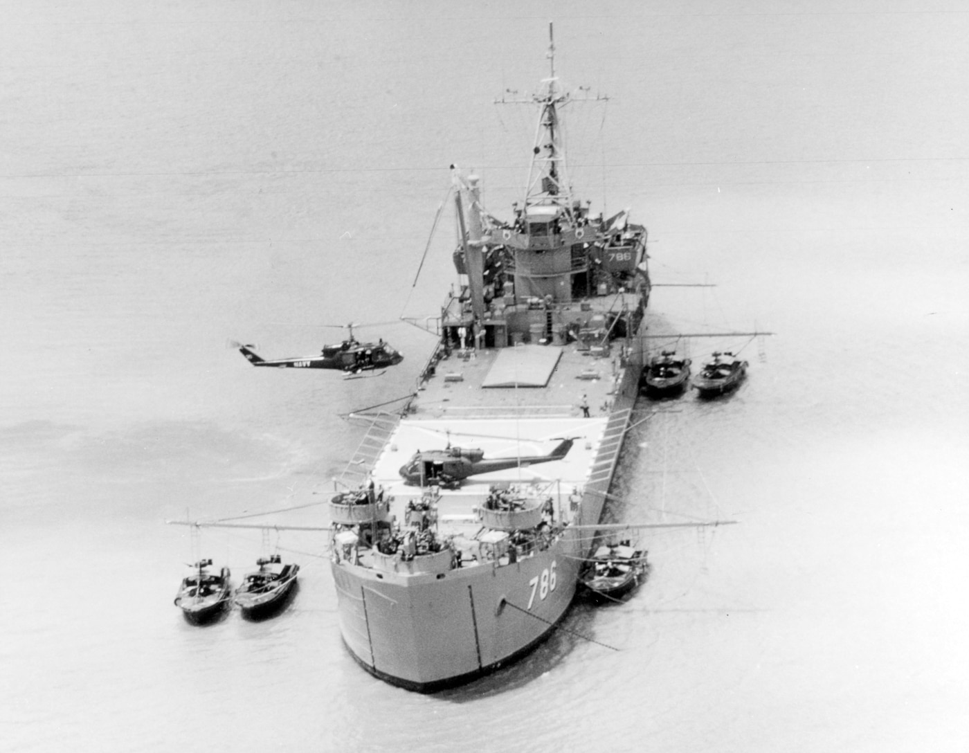 USS Garrett County LST-786 providing support for patrol river boats and UH-1B attack helicopters