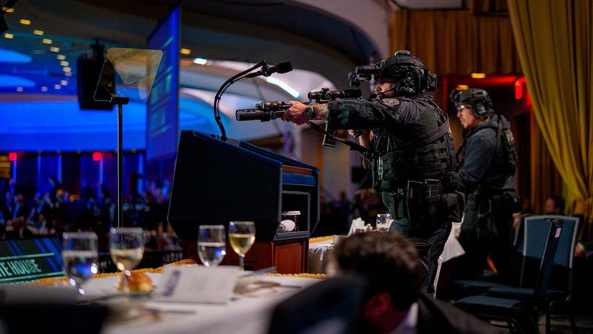 Armed Secret Service agents stand on stage during a shooting incident at the Washington Hilton.