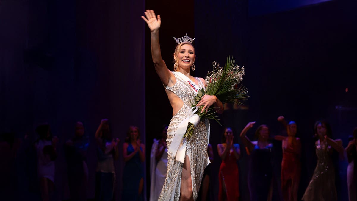Ashlyn Mercier waves at an event.
