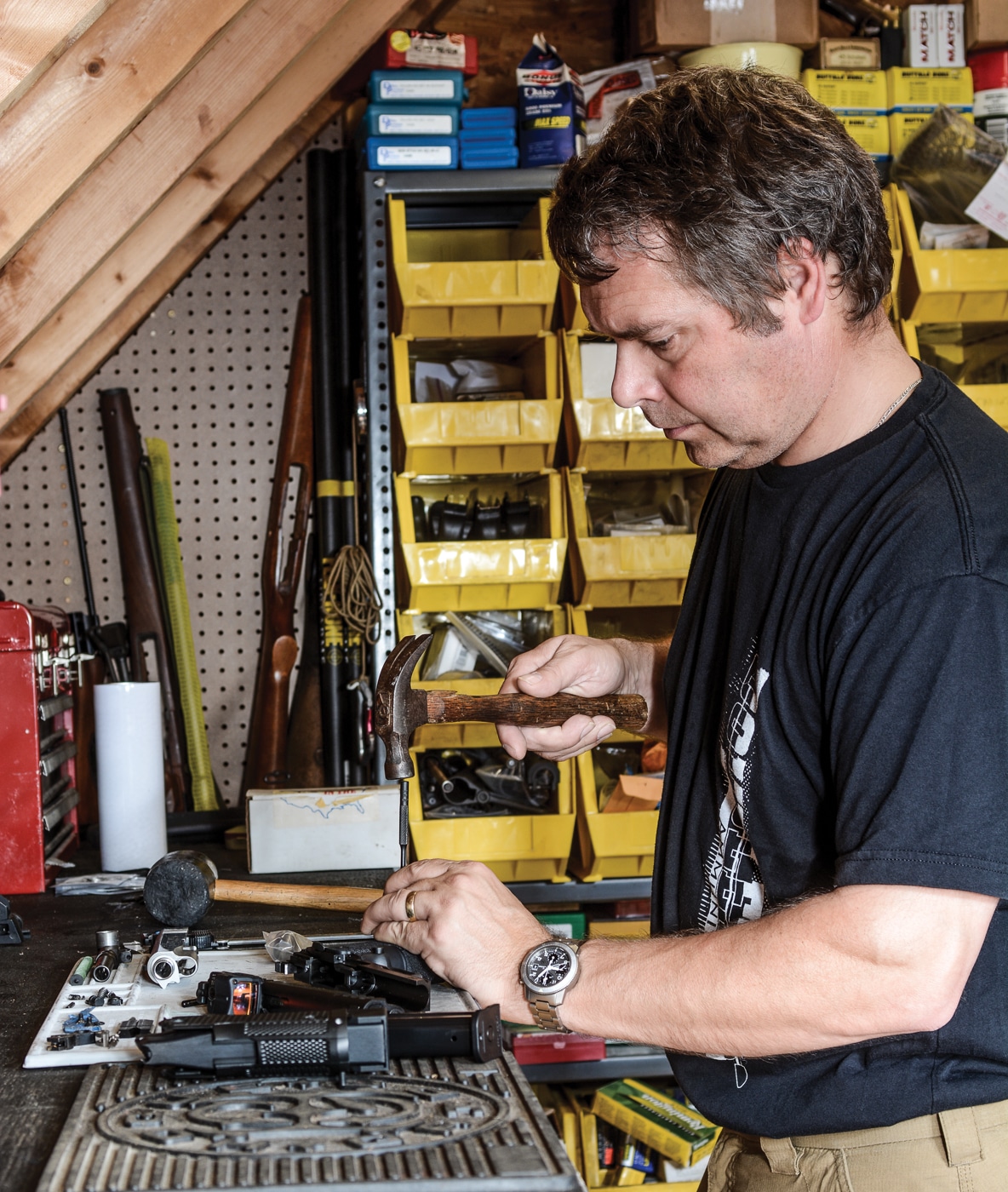 author is shown here at the bench assembling the Ed Brown Metal Grip Module project gun for the article