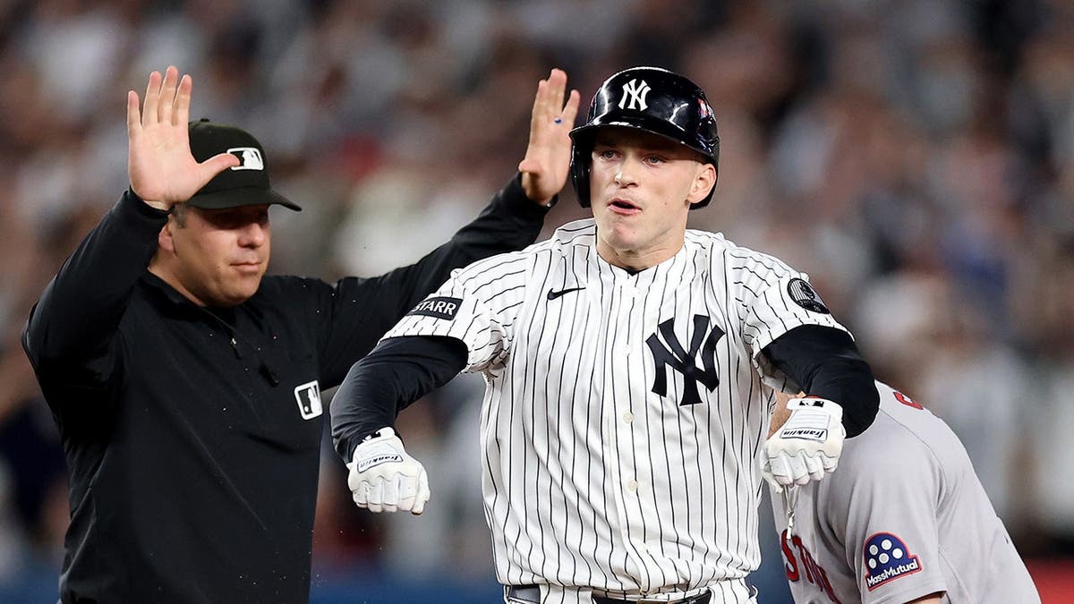 Ben Rice celebrates on second base after hitting a double at Yankee Stadium.