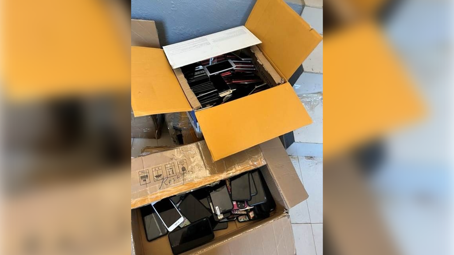 Boxes of phones from alleged Chinese-run scam compound