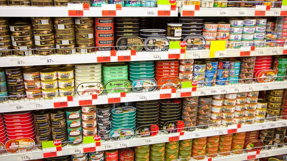Canned fish on supermarket shelves.