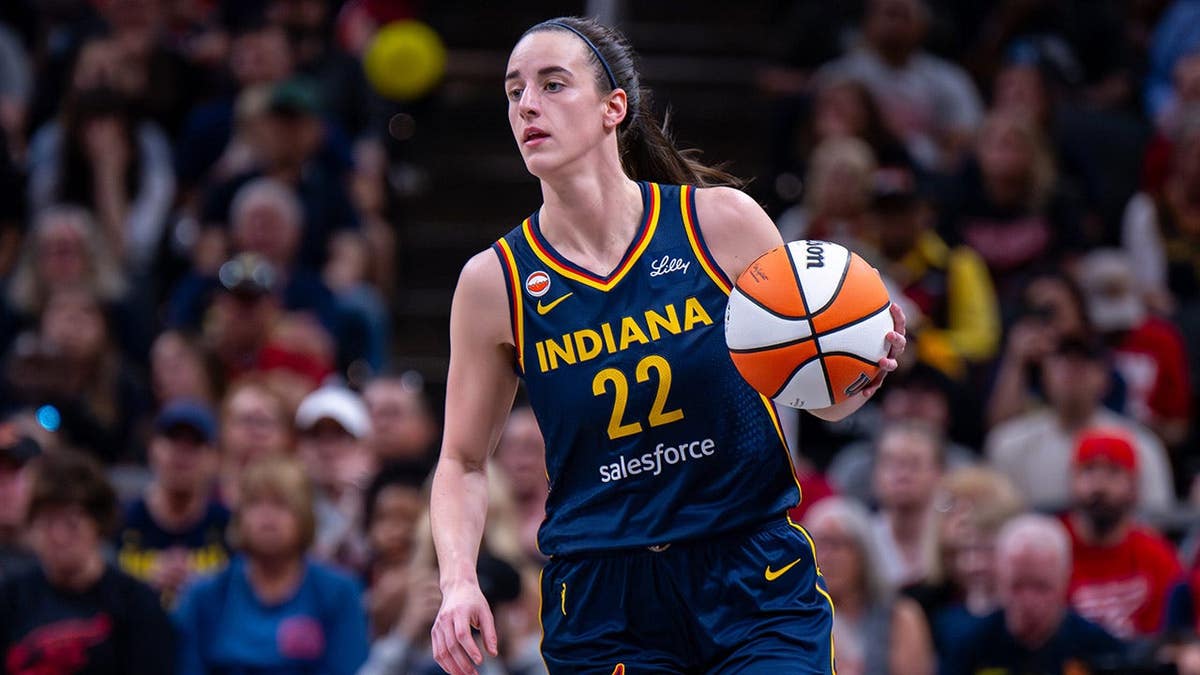 Indiana Fever guard Caitlin Clark dribbling basketball during game at Gainbridge Fieldhouse