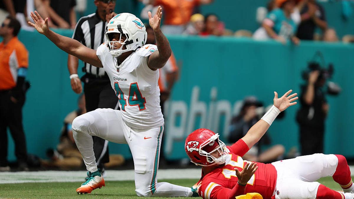 Chop Robinson #44 and Patrick Mahomes #15 react to a call during an NFL game.