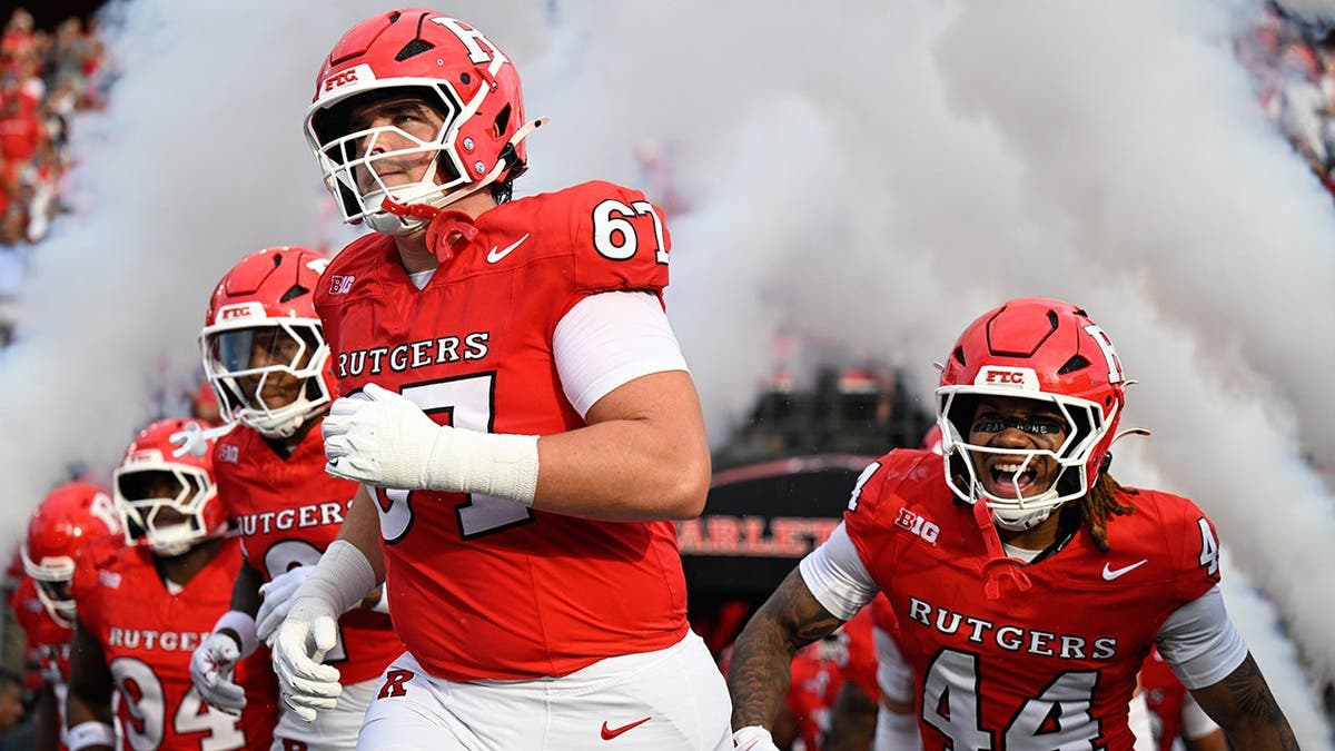 Chris Vigna and Tariq Hayer run onto the field at SHI Stadium.