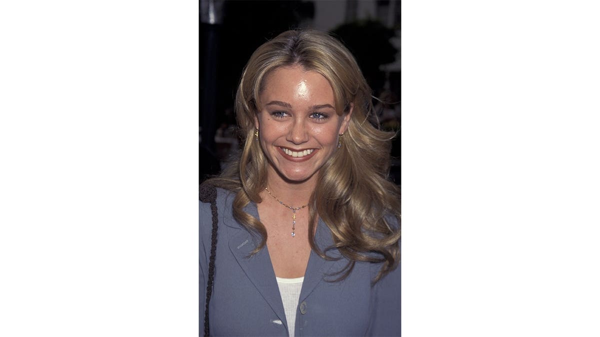 Christine Taylor smiles in a portrait.