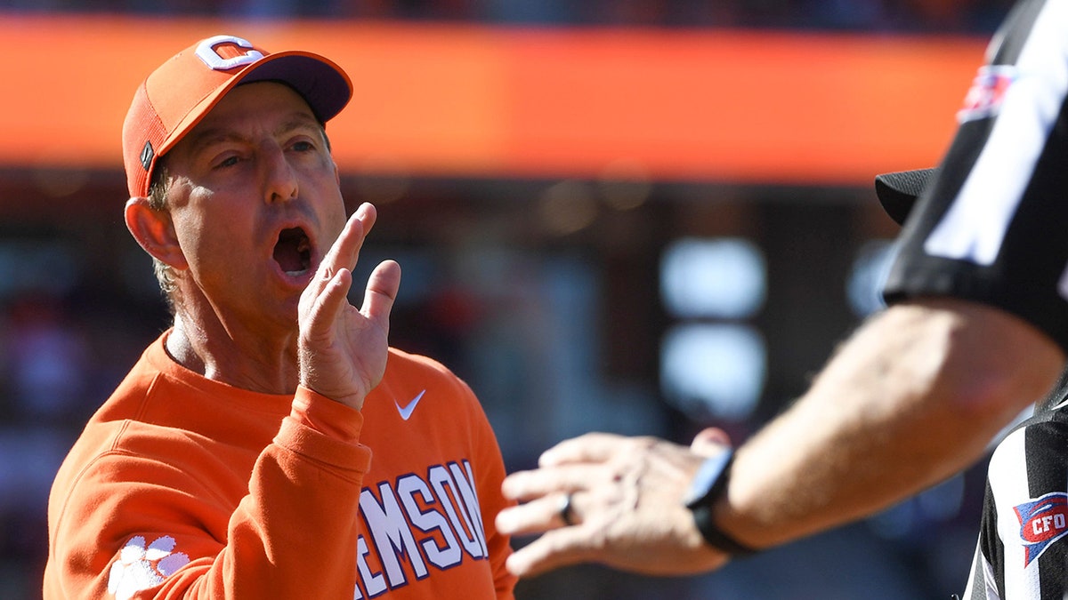 Dabo Swinney interacts with a referee