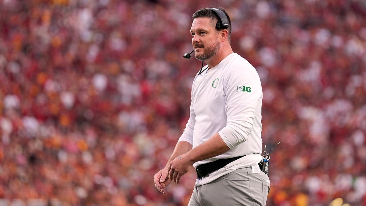 Dan Lanning stands on the field during a college football game in Los Angeles.