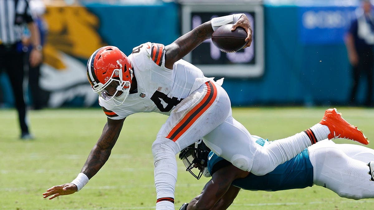 Deshaun Watson of the Cleveland Browns is tackled by Ventrell Miller of the Jacksonville Jaguars.