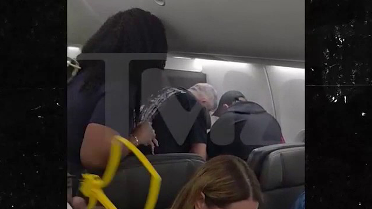 Crew and passengers restraining a man on a flight