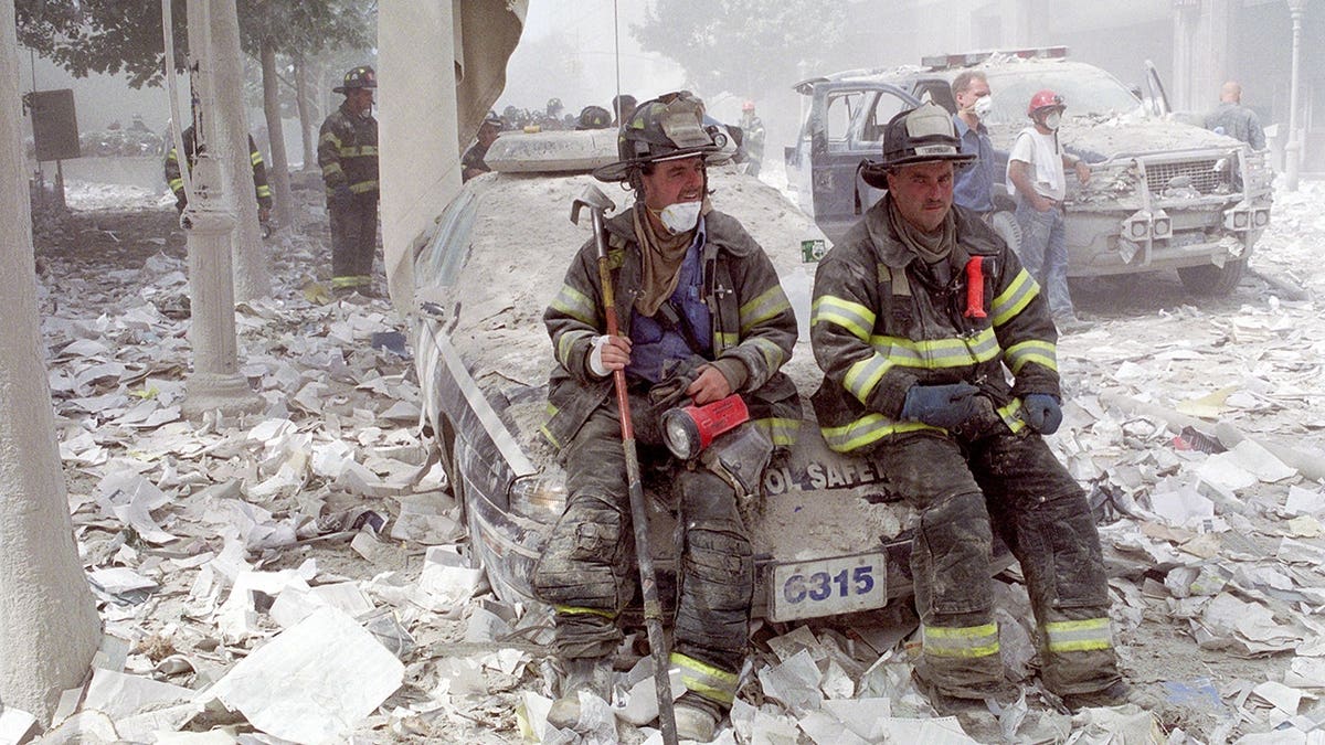 Firefighters gather near ground zero after the World Trade Center attack on September 11, 2001.