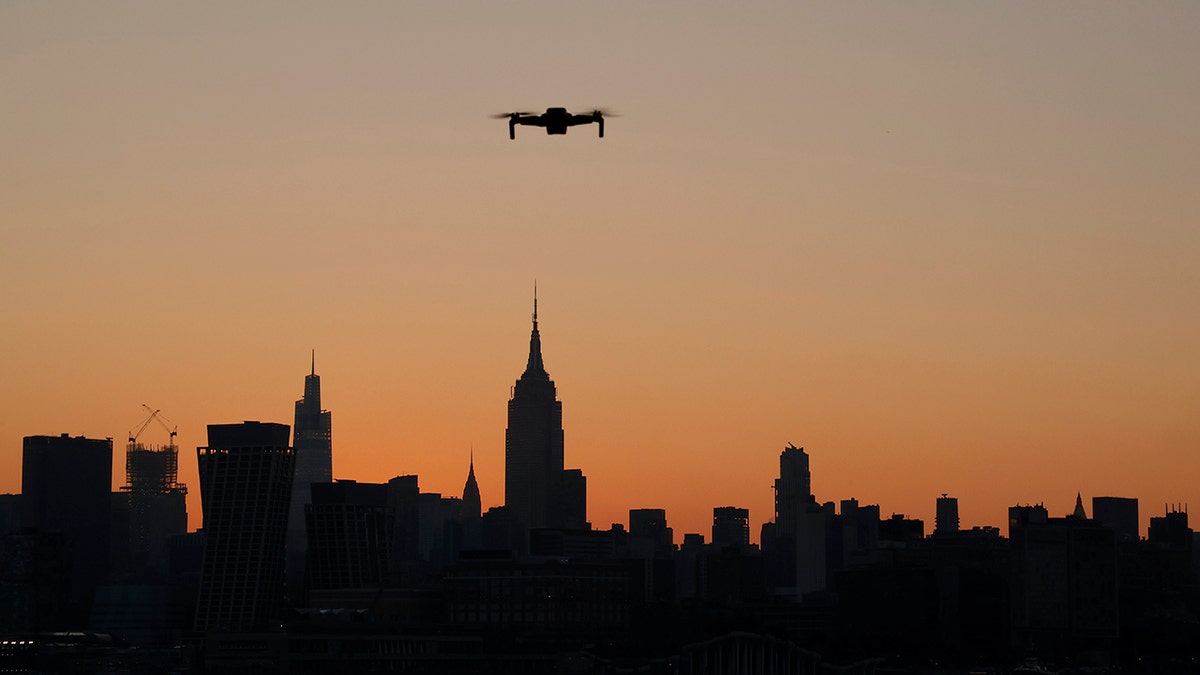A drone flying during sunset in New York City.