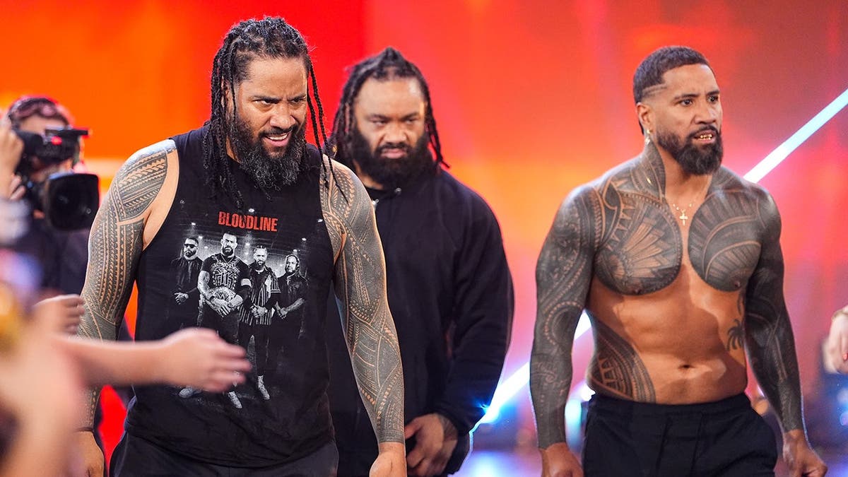 Jimmy Uso, Jacob Fatu and Jey Uso enter the ring at Fiserv Forum.
