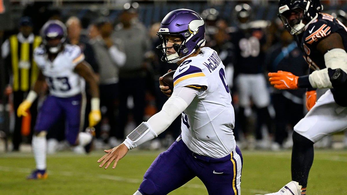 J.J. McCarthy runs with ball